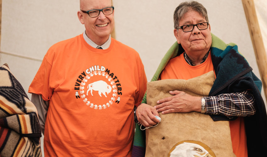 Dr. Tim Rahilly, PhD, president and vice-chancellor of MRU, left, and Espoom taah (helper) Roy Bear Chief.