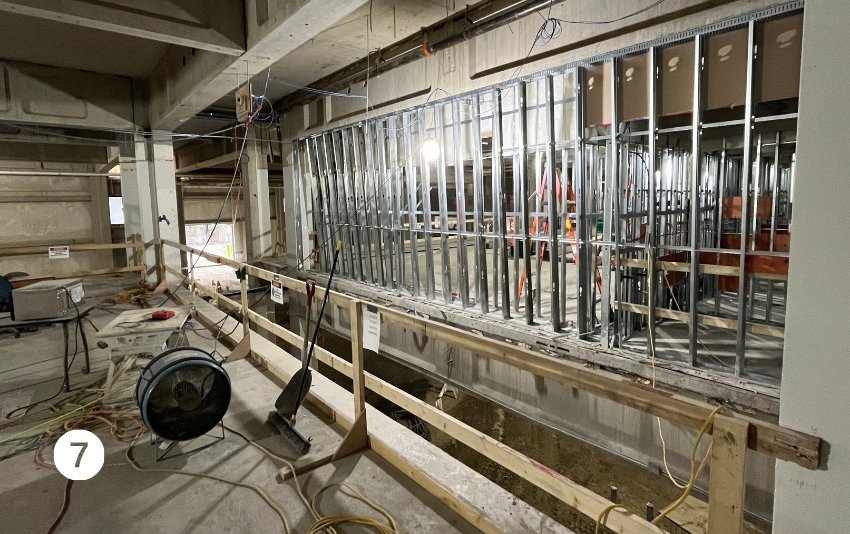 Photo 7 shows a framed wall on Level 2.