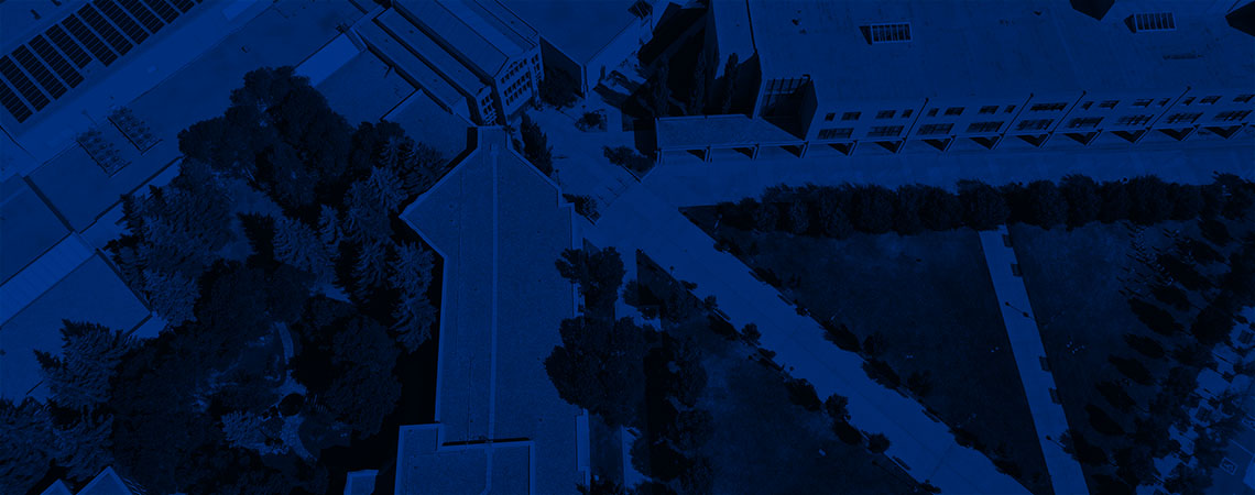 Aerial photo of Mount Royal University's East Gate lawn, tinted navy blue.