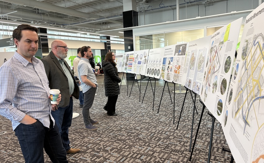 A man reviews information on billboards in the Ideas Lounge.