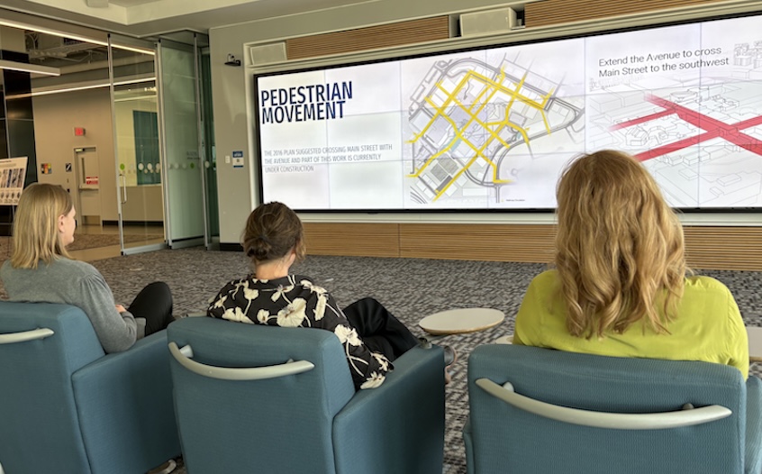 Participants watch a presentation of the draft LRDP on the visualization wall. 