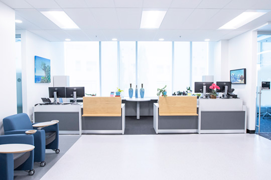 Photo of the entrance to Student Learning Services. The photo faces the two adjacent administrative desks and shows some of the waiting area.