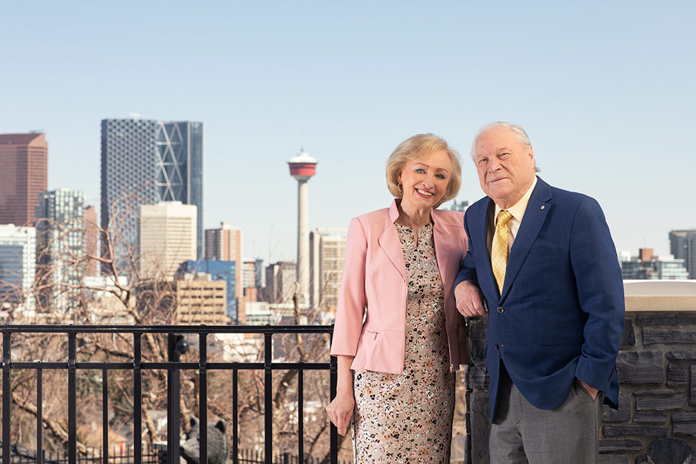 Ruth and Don Taylor standing on a balcony overlooking downtown Calgary.