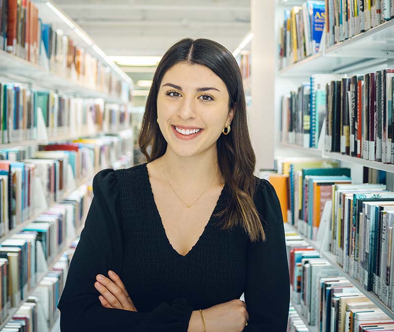Bianca Veltri in the stacks of the Riddell Library and Learning Centre.