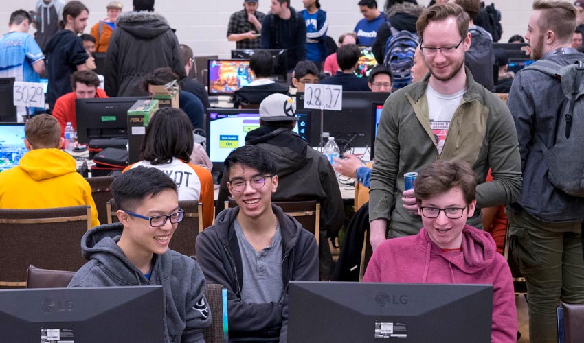 Photo of individuals competing for prizes in front of an audience.