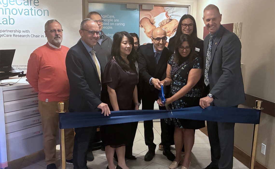 A group of individuals cutting a ceremonial ribbon at the opening of the AgeCare Innovation Lab in Seton.