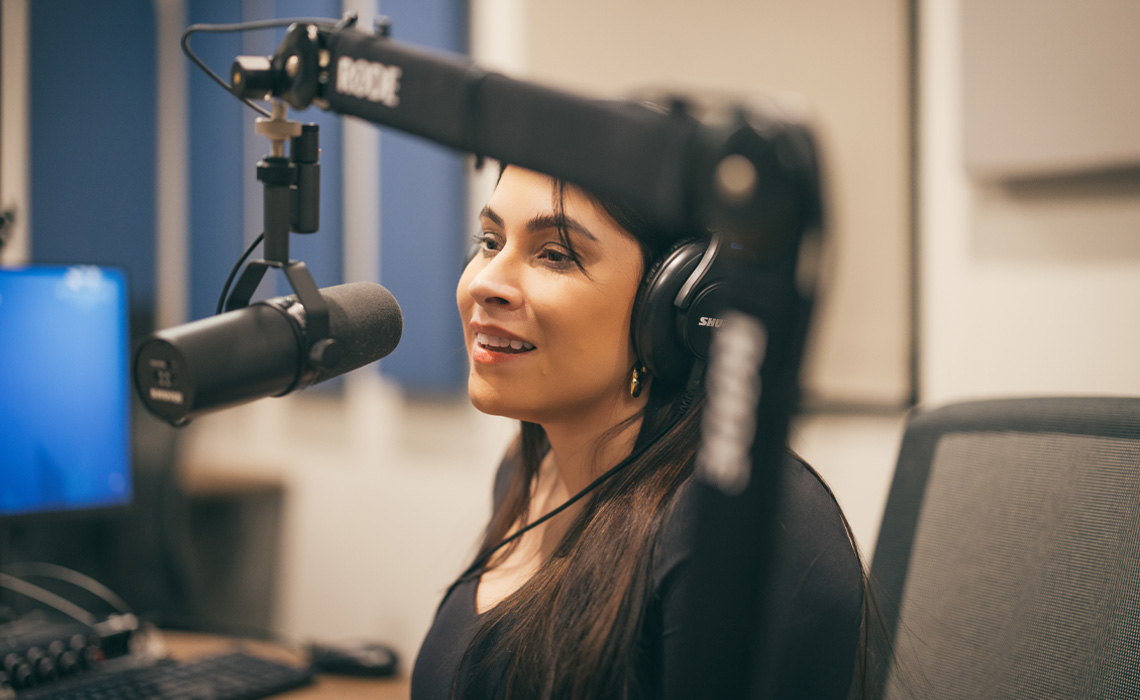 Ashley King wearing headphones, engaged in audio production.