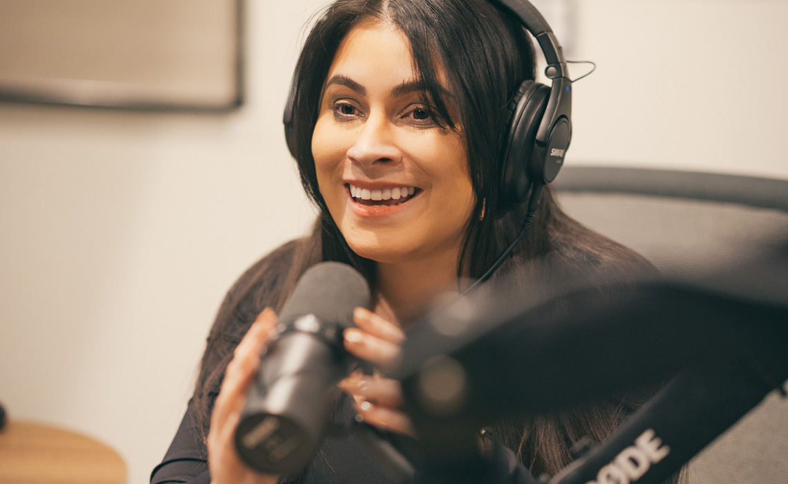 Ashley King wearing headphones, engaged in audio production.