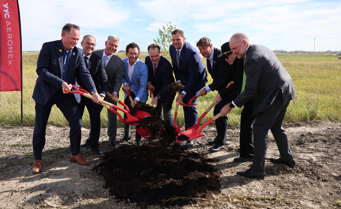 Several people participate in a groundbreaking ceremony.