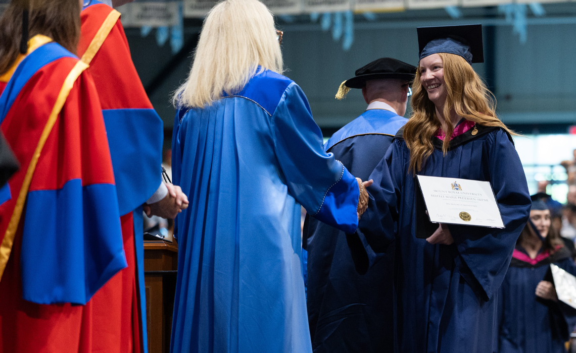 Brielle Pedersen crosses the stage at graduation
