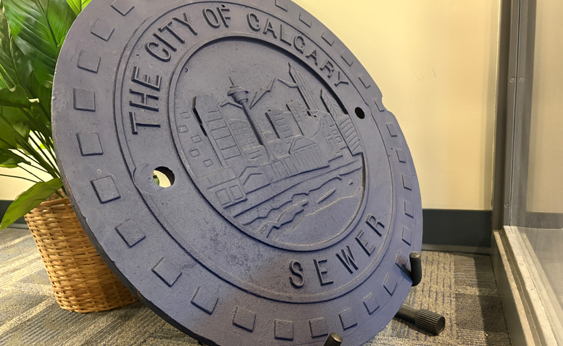 A City of Calgary manhole cover, referred to as "The Trophy."