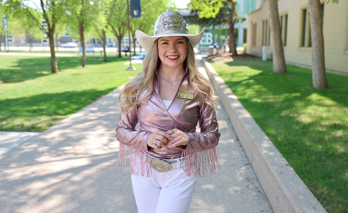 Sarah O’Brien stands confidently, showcasing a stylish and casual western-inspired outfit.