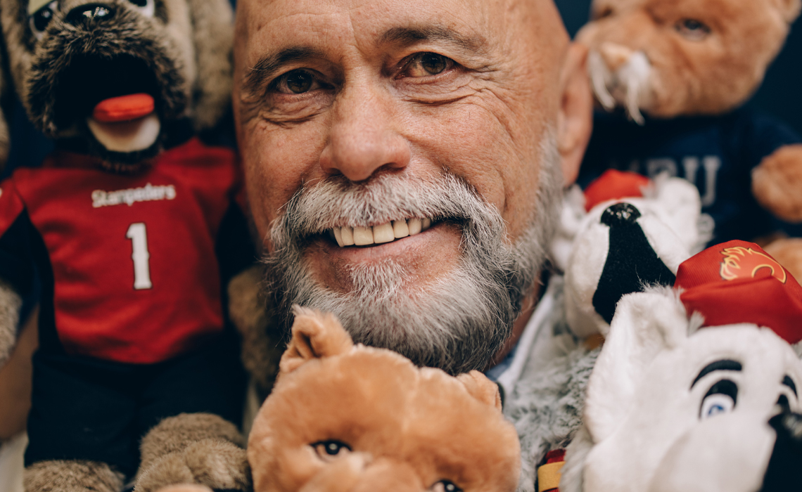 Grant Kelba surrounded by his mascot friends.