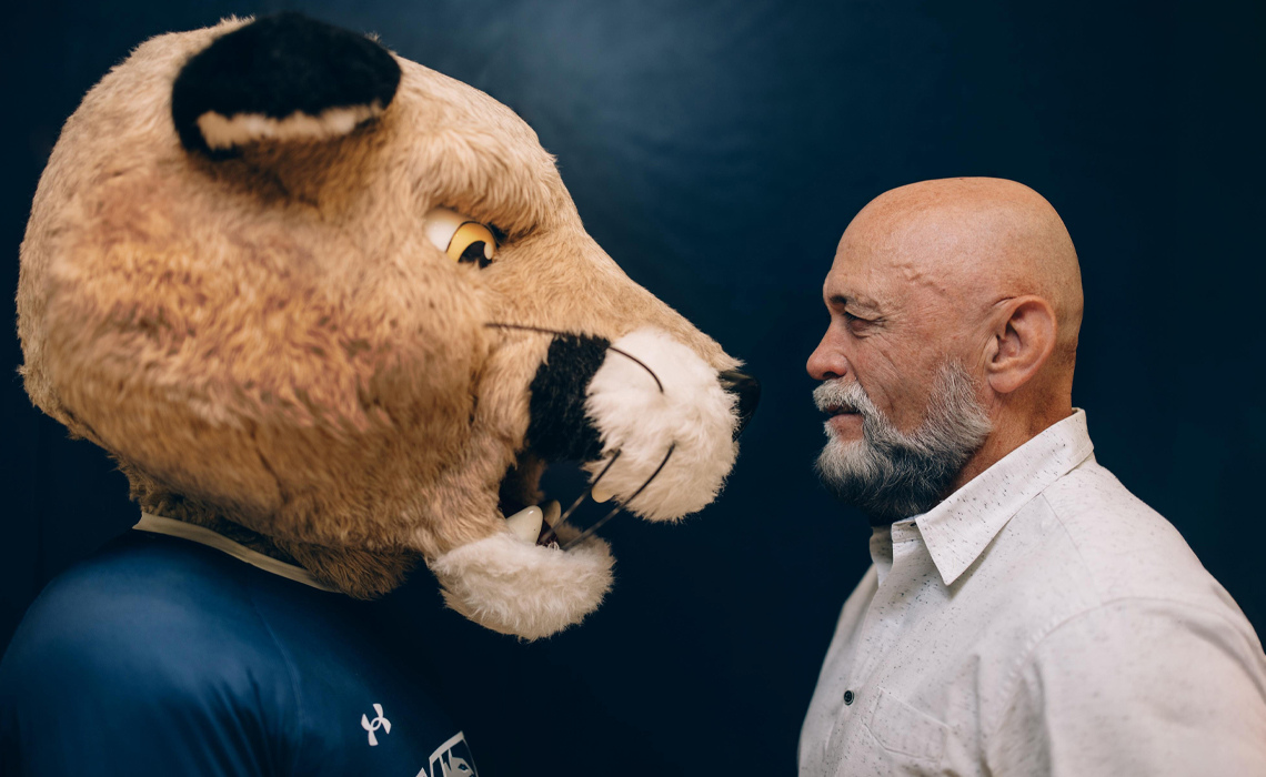Grant Kelba, right, comes face to face with MRU’s mascot, Calvin the Cougar.