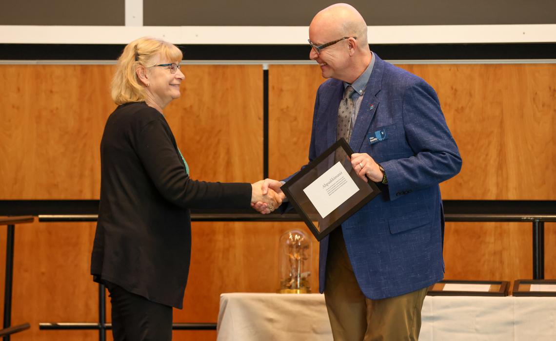 Retiree Cindy Hamonic receives congratulations from Mount Royal President and Vice-Chancellor Tim Rahilly, PhD, at the Long Service and Retirement Brunch.