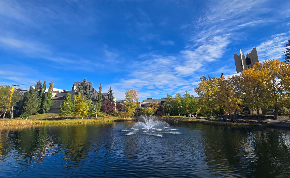 Fall foliage surrounds Charlton Pond at Mount Royal University.