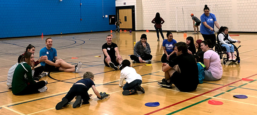 Photo of kids and facilitators playing in the Mount Royal University gymnasium.