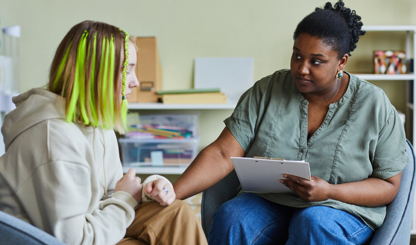 A nurse comforting a young woman.