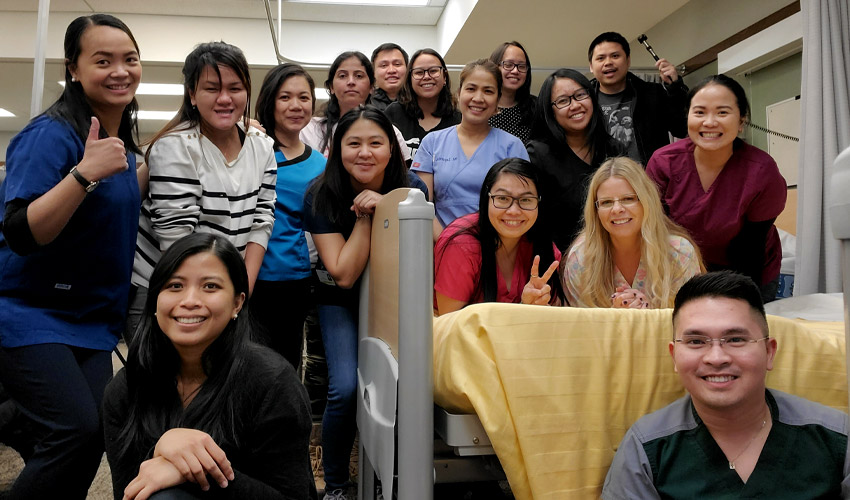 Photo of Robyn Stewart with Bridge to Canadian Nursing students in lab.