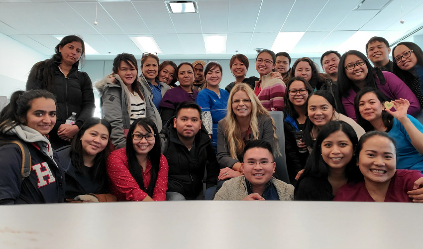 Photo of Robyn Stewart with Bridge to Canadian Nursing students in classroom.