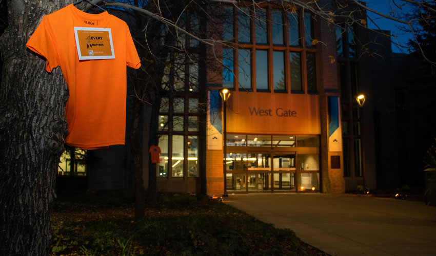 An orange shirt is displayed at the west entrance of campus.