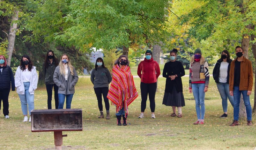 The Catamount Fellowship cohort standing in a park wearing face masks and socially distancing.