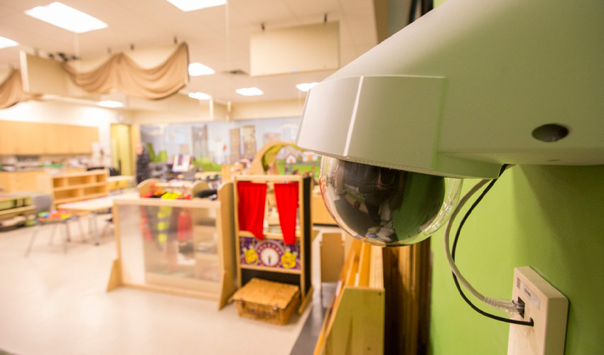 A wall-mounted camera in the Child Development Lab.