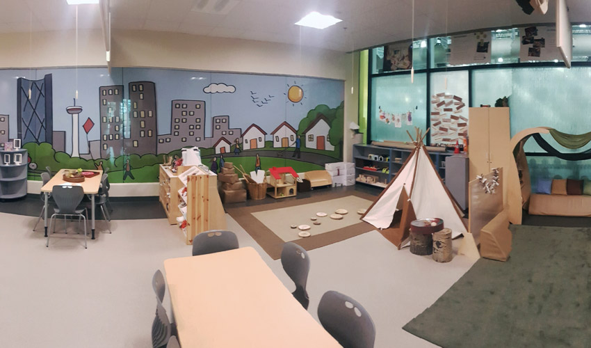 A view of the Child Development Lab showcasing the child tipi and a mural of Calgary's downtown.