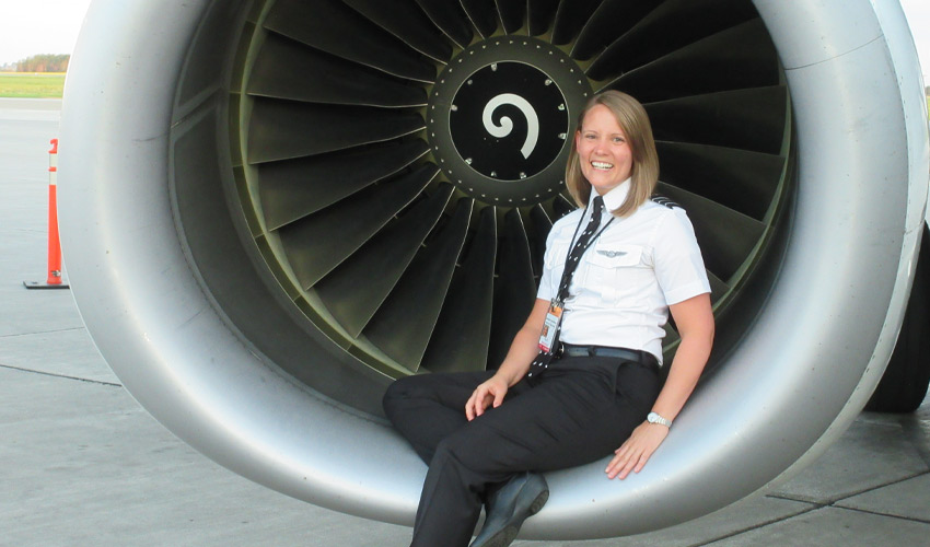 Christina Dethmers posing against a jet engine.