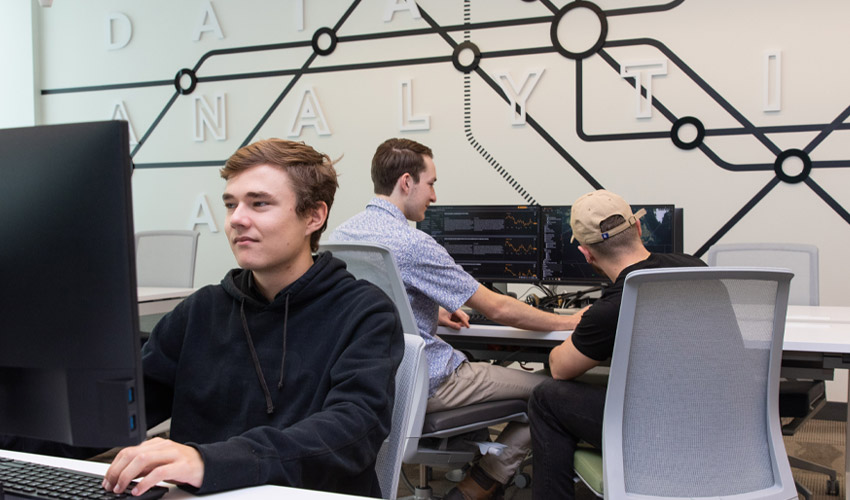 Photo of students working in the CN Supply Chain Analytics Lab.