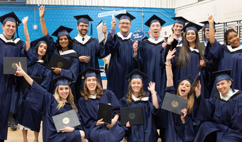 Photo of Mount Royal University graduates celebrating.