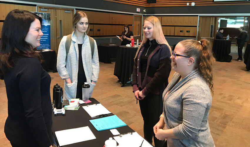 Personal Fitness Trainer Diploma students, including Britney Hannaford, far right, speak with Jodie Boettger, a talent acquisition specialist with World Health/Spa Lady/Bankers Hall Club, at the recent career fair held in Ross Glen Hall.