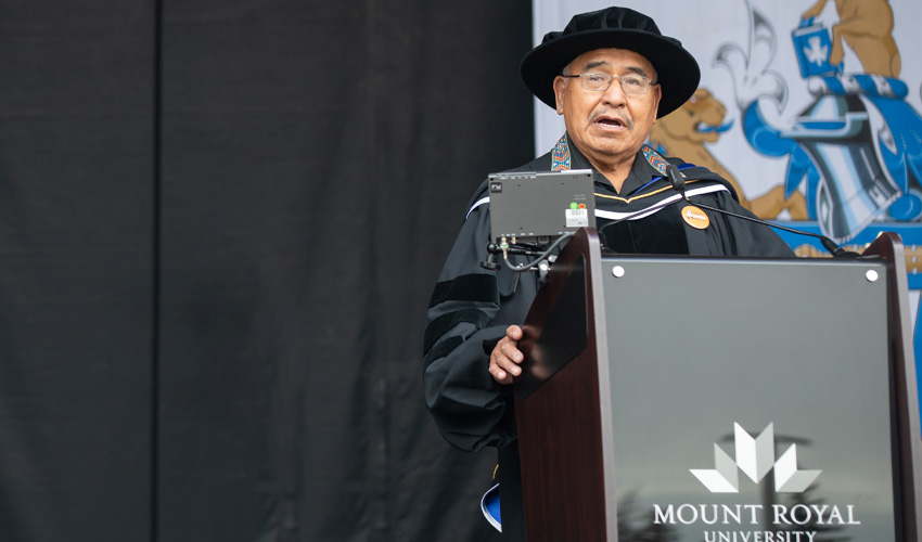 Clarence Wolfleg Senior (Elder Miiksika’am) addresses Spring 2021 graduates.