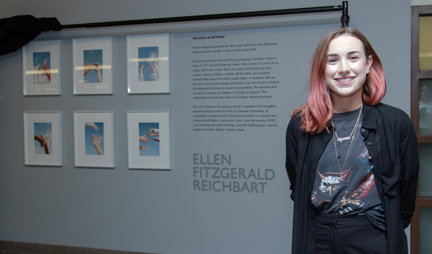 Ellen FitzGerald Reichbart poses in front of 6 photos of hands