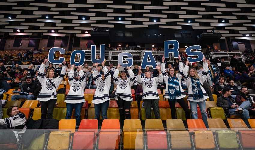 Cougars fans and parents cheering the women's hockey team on, contributing to the incredible atmosphere of the final game.