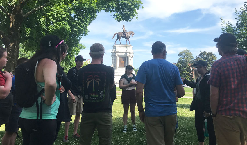 Photo of students near a statue of Robert E. Lee.