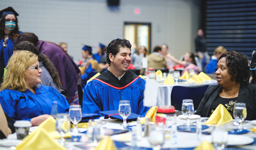 Graduates celebrate their achievement at the event held in the Triple Gym.