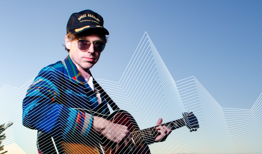 Joel Plaskett posing with his guitar.