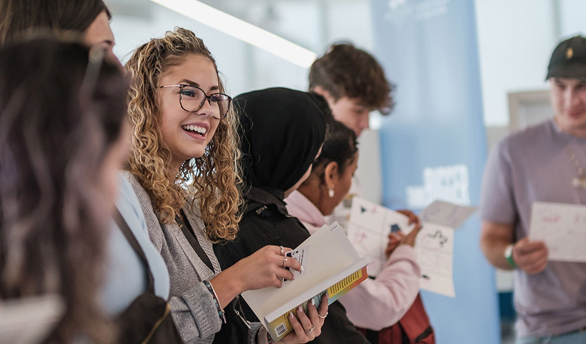 Two women at MRU speaking to future students during an Open House event.