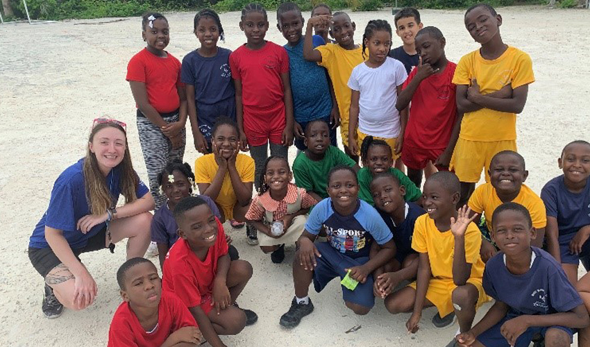 Photo of Margo Elliot with students from Wesley Methodist School in Providenciales.