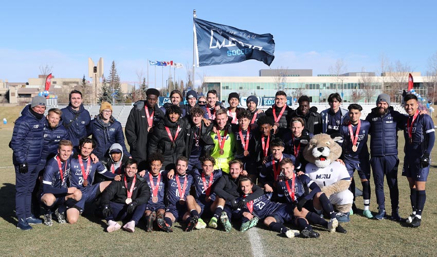 The Cougars Men's soccer team poses for a photo after winning bronze in Canada West.