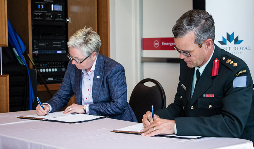 signs a Memorandum of Understanding on behalf of the University