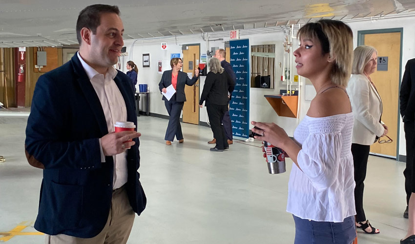 Advanced Education Minister Demetrios Nicolaides speaks with SAMRU VP External Tera Leigh Cardinal following the announcement.