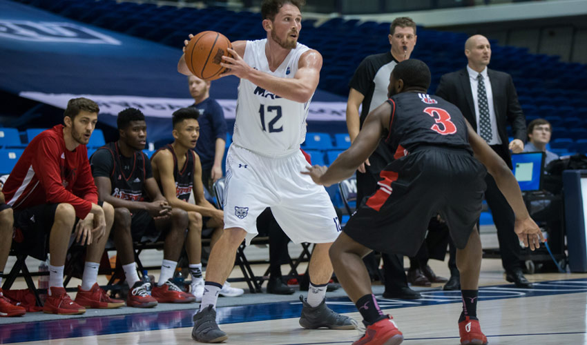 Mount Royal University alumnus Noah Lewis competing in a basketball game.