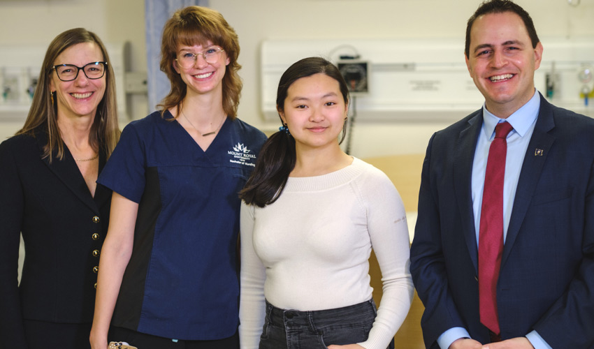 Elizabeth Van Den Kerkhof (director of the School of Nursing and Midwifery), Lydia Schouten (nursing student), Nancy Tran (nursing student), and Demetrios Nicolaides (Advanced Education Minister).