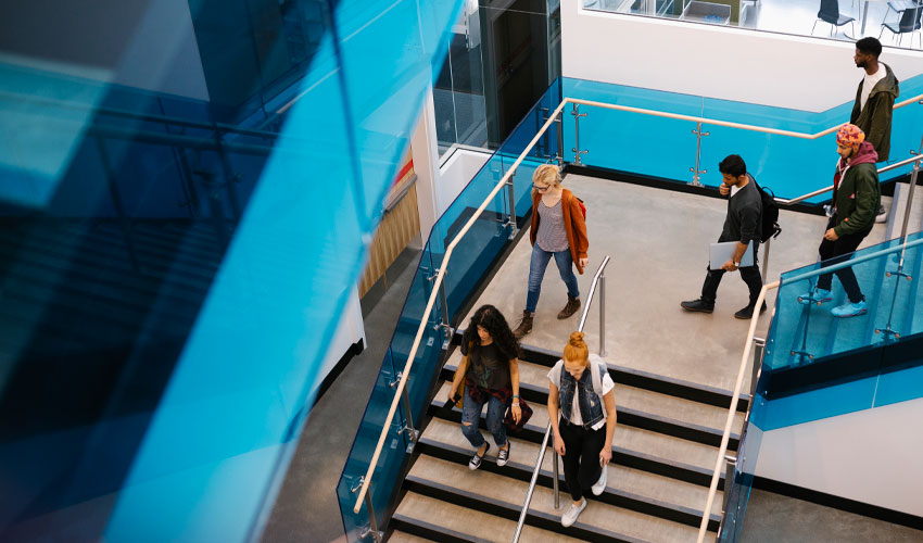 Photo of University students walking through the Riddell Library and Learning Centre.