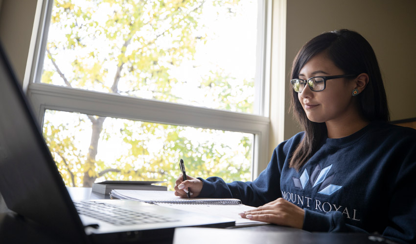 A Mount Royal University student working on an assignment.