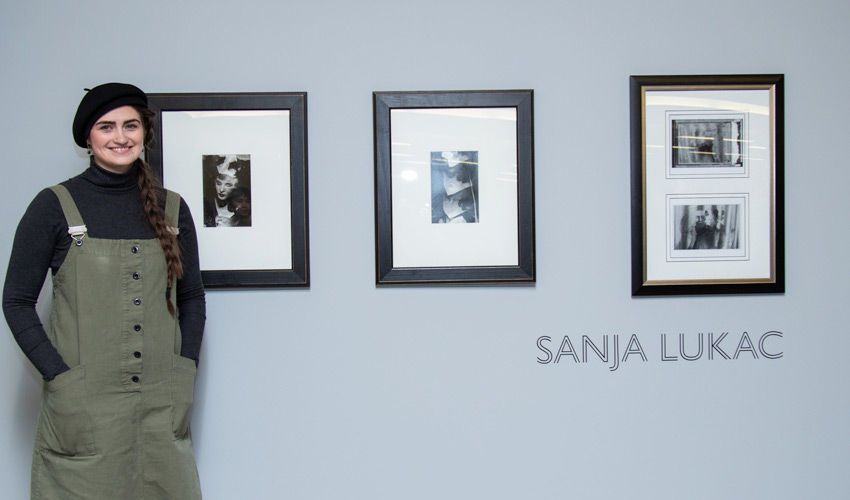 Sanja Lukac poses with four of her darkroom prints
