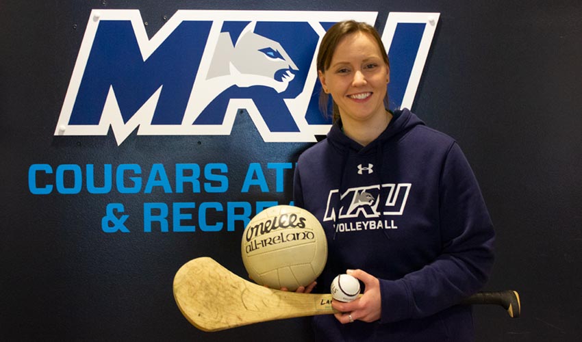 Ciara Lane with equipment from Gaelic football and hurling