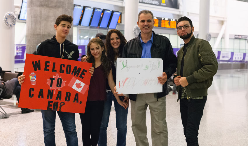 People await the first plane's arrival of Syrian refugees at Toronto's Pearson International Airport.